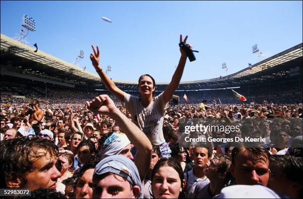 General view of the crowd during the Live Aid concert at Wembley Stadium on 13 July, 1985 in London, England. Live Aid was watched by millions around...