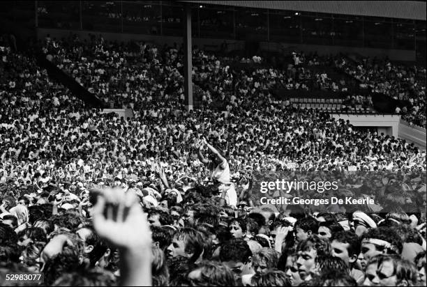 General view of the crowd during the Live Aid concert at Wembley Stadium on 13 July, 1985 in London, England. Live Aid was watched by millions around...