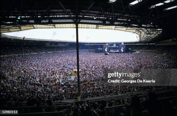 General view of the crowd and stage during the Live Aid concert at Wembley Stadium on 13 July, 1985 in London, England. Live Aid was watched by...