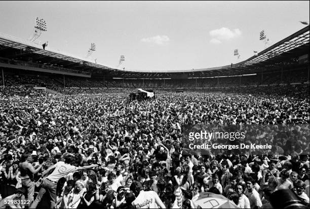 General view of the crowd during the Live Aid concert at Wembley Stadium on 13 July, 1985 in London, England. Live Aid was watched by millions around...