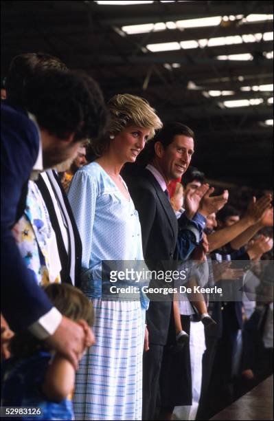 Princess Diana and HRH Prince Charles stand in the crowd during the Live Aid concert at Wembley Stadium on 13 July, 1985 in London, England. Live Aid...