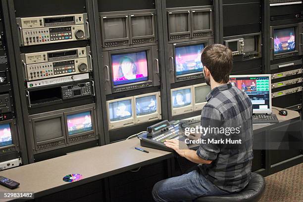 video editor at work in a tv editing control room at a cable tv studio - broadcast control room stock pictures, royalty-free photos & images