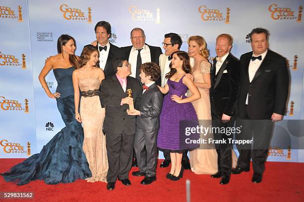 Cast and producers pose in the press room with the Best Television Series - Musical or Comedy award for Modern Family at the 69th Annual Golden Globe...