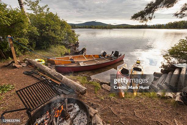 island campsite with canoes and kayaks at the lakeside, lake umbagog, new hampshire, usa - national wildlife reserve fotografías e imágenes de stock