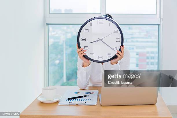 business time concept - clock person desk stockfoto's en -beelden