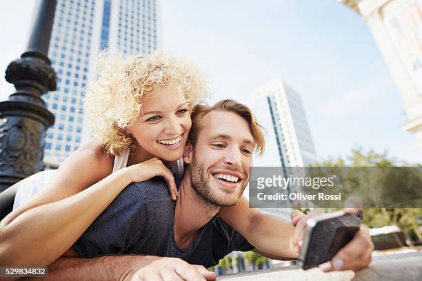 happy young couple taking selfie - hesse germany stock-fotos und bilder