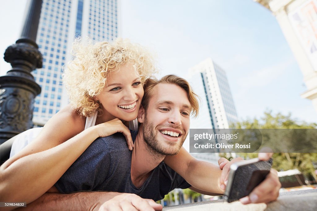 Happy young couple taking selfie