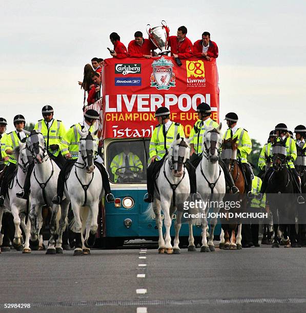 The Liverpool team hold aloft their newest trophy to the thousands of fans gathered to welcome them home, 26 May following their Champions League...