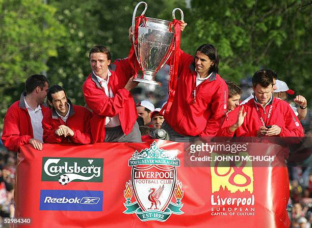 Liverpool players Jamie Carragher, Luis Garcia, Vladimir Smicer, Milan Baros, Steven Gerrard and John Arne Riise hold up the Champion's League trophy...