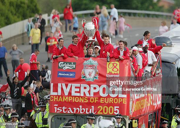Steven Gerrard and John Arne Riise hold the trophy aloft during the homecoming victory parade through the streets of Liverpool on May 26, 2005 in...