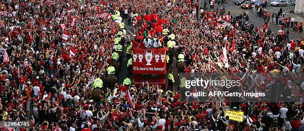 Thousands of fans cheer the Liverpool football team during a parade to welcome them home, 26 May following their Champions League victory over AC...