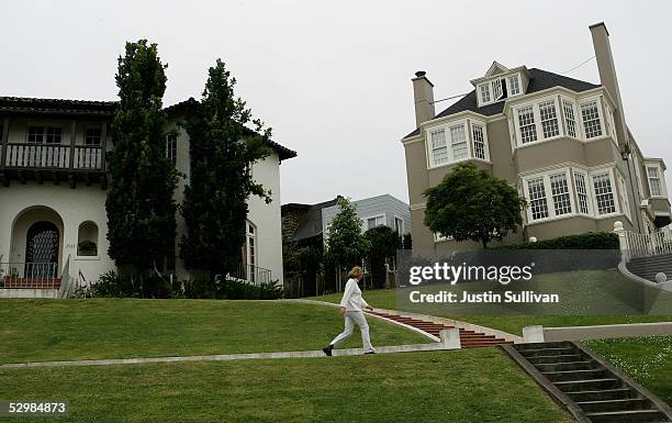 Woman walks past luxury homes May 26, 2005 in the Sea Cliff neighborhood of San Francisco, California. According to a study released Wednesday by San...