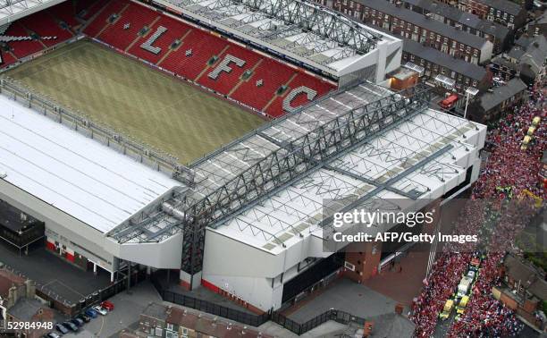 Thousands of fans cheer the Liverpool football team as they pass Anfield during a parade to welcome them home, 26 May following their Champions...