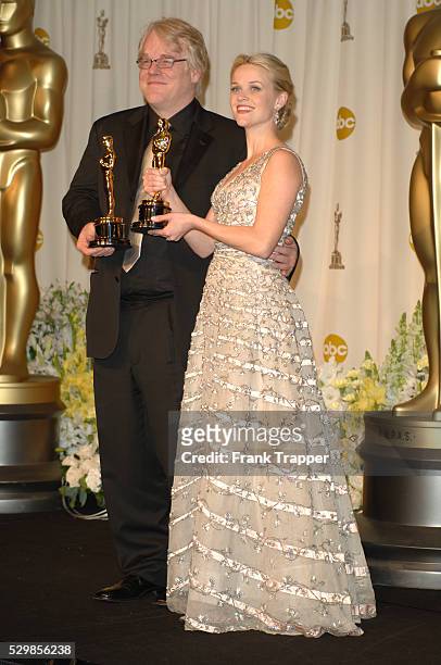 Philip Seymour Hoffman, winner of Best Performance by an Actor in a Leading Role for "Capote" and Reese Witherspoon, winner of Best Performance by an...