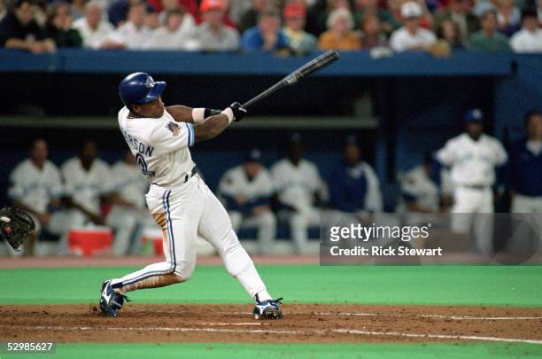 Rickey Henderson of the Toronto Blue Jays swings at Philadelphia Phillies pitch during game 1 of the World Series at the SkyDome in Toronto, Ontario,...