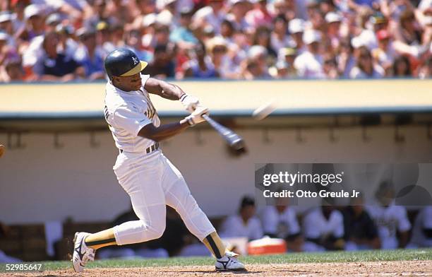 Rickey Henderson of the Oakland Athletics connects with a pitch during the 1989 season game at the Oakland-Alameda County Coliseum in Oakland,...