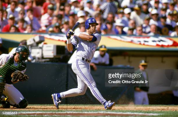 Roberto Alomar of the Toronto Blue Jays swings at an Oakland Athletics pitch during game 5 of the ALCS on October 12 at the Oakland-Alameda County...