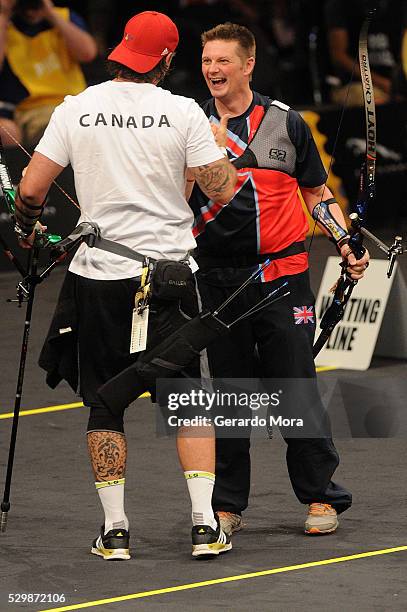 Gareth Peterson and Nicolas Meunier greet after Archery Finals at the Invictus Games at ESPN Wide World of Sports complex on May 9, 2016 in Lake...