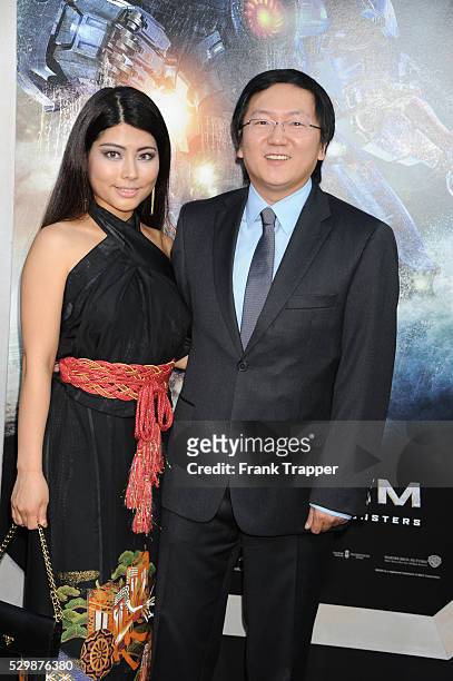 Actor Masi Oka and guest arrive at the premiere of Pacific Rim held at the Dolby Theater in Hollywood.