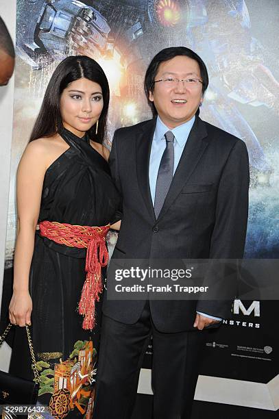 Actor Masi Oka and guest arrive at the premiere of Pacific Rim held at the Dolby Theater in Hollywood.