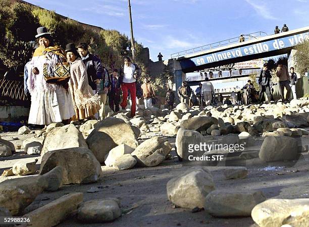 People avoid stones blocking La Paz-El Alto road, 27 May 2005. Protests demanding nationalization of oil and gas resources, resumed today after an...