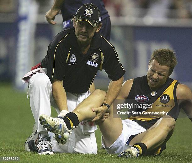 Nathan Brown for Richmond lies on the ground after breaking his leg during the AFL round 10 match between the Melbourne Demons and Richmond Tigers at...