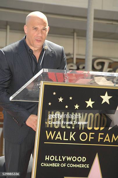 Actor Vin Diesel posing at the ceremony that honored him with a Star on the Hollywood Walk of Fame.