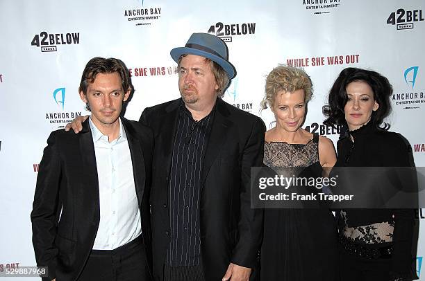 Actor Lucas Haas, producer Don Murphy, actress Kim Basinger and writer/director Susan Montford arrive at the premiere of "While She Was Out" held at...