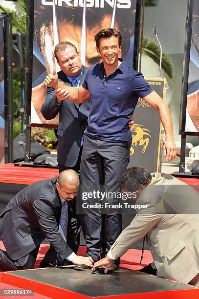 Australian actor Hugh Jackman leaves his hand and footprints in the cement in front of Grauman's Chinese Theatre.