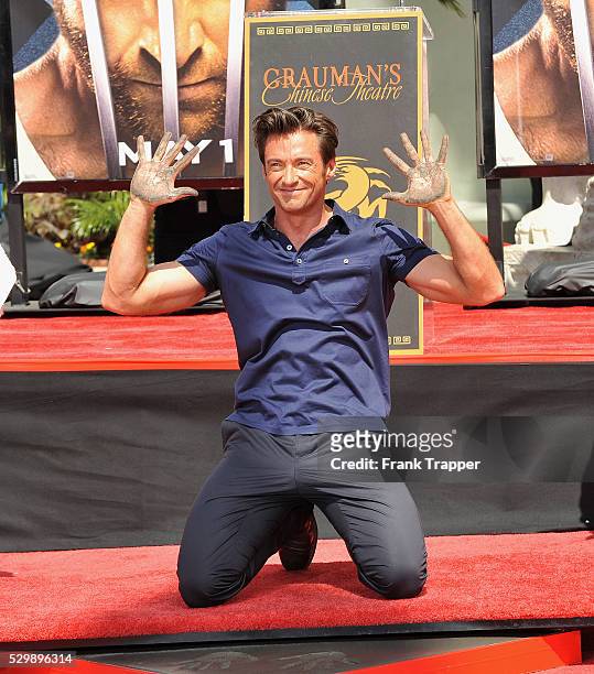 Australian actor Hugh Jackman leaves his hand and footprints in the cement in front of Grauman's Chinese Theatre.