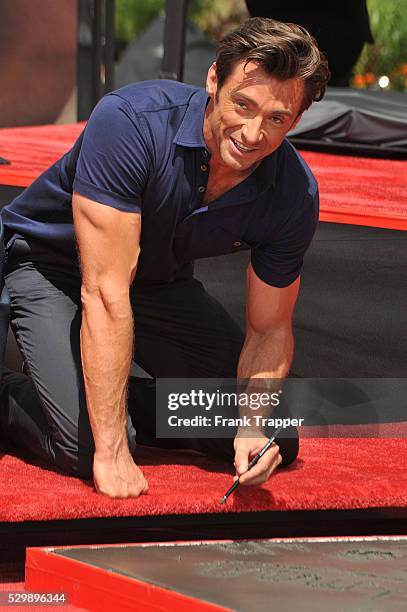 Australian actor Hugh Jackman leaves his hand and footprints in the cement in front of Grauman's Chinese Theatre.