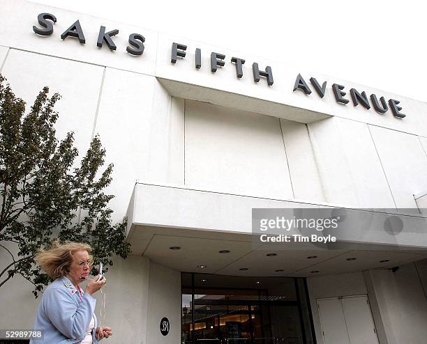 Woman talks on her cell phone outside the Saks Fifth Avenue department store at Old Orchard shopping center May 27, 2005 in Skokie, Illinois. Saks...