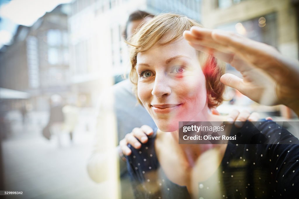 Smiling couple behind window