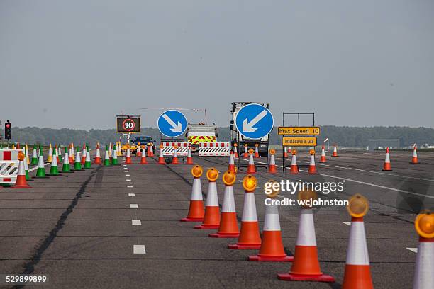 highway maintenance road block traffic cones and fence line - traffic management stock pictures, royalty-free photos & images