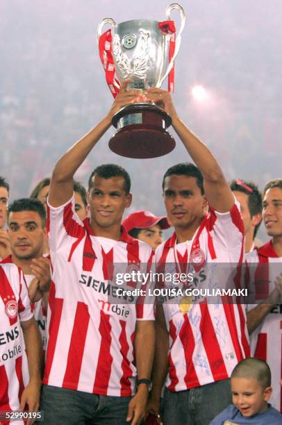 Olympiakos Piraeus football team's Brazilian stars, Rivaldo and Giovanni raise the Cup, during the official award ceremony in the Karaiskaki stadium...