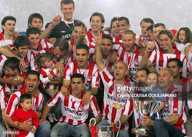 Olympiakos Piraeus football team celebrates their championship and the Cup win during the official award ceremony in the Karaiskaki stadium in...