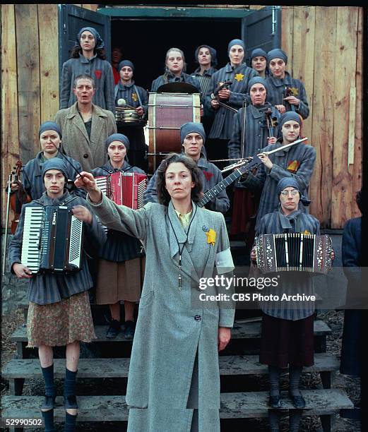 American actress Jane Alexander conducts an orchestra consisting of female Auschwitz prisoners in the made-for-television movie 'Playing for Time,'...