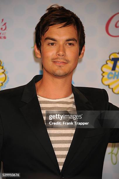 Actor Tyler Blackburn posing in the press room at the 2014 Teen Choice Awards held at the Shrine Auditorium.