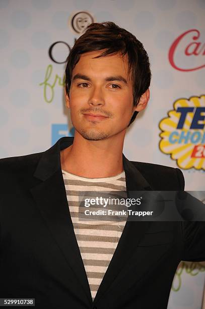 Actor Tyler Blackburn posing in the press room at the 2014 Teen Choice Awards held at the Shrine Auditorium.