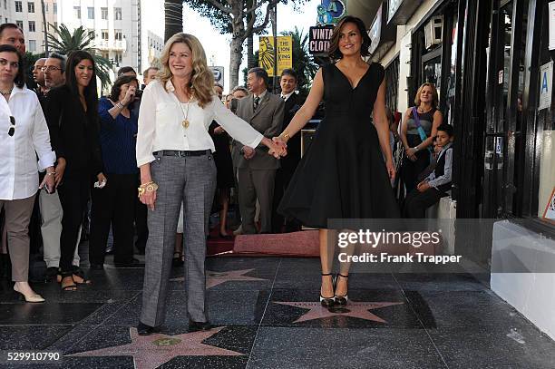 Actress Mariska Hargitay stands on her star while her sister Tina Hargitay stands on the star of their mother Jayne Mansfield at the ceremony that...