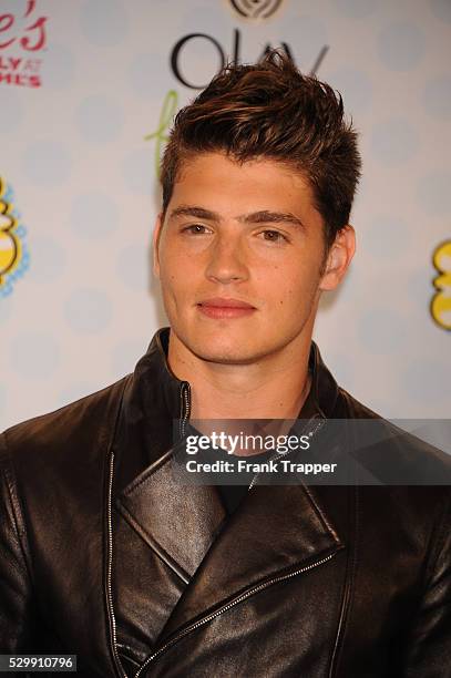 Actor Gregg Sulkin posing in the press room at the 2014 Teen Choice Awards held at the Shrine Auditorium.
