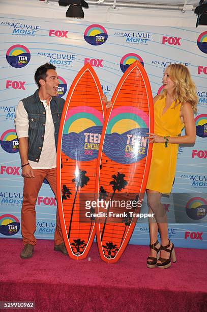 Actors Michael Trevino and Candice Accola, winners of Choice Fantasy/Sci-Fi Show award, pose in the press room at the 2012 Teen Choice Awards held at...