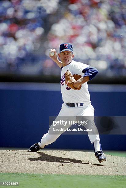 Nolan Ryan of the Texas Rangers pitches during a 1989 MLB game at The Ballpark in Arlington in Arlington, Texas.