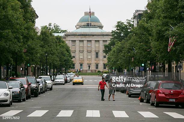Couple walks near the North Carolina State Capitol on Fayetteville Street in Raleigh, N.C., on Monday, May 9, 2016. Gov. Pat McCrory and his...