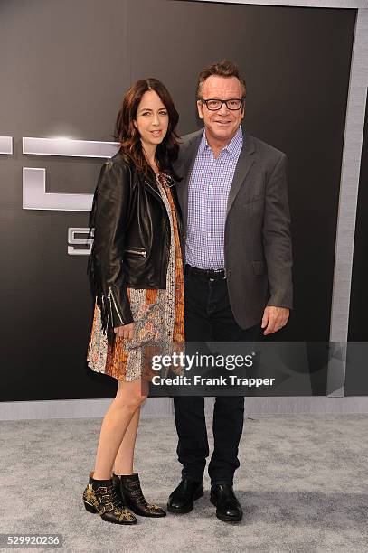 Actor Tom Arnold and wife Ashley Groussman arrive at the premiere of "Terminator Genisys" held at the Dolby Theater in Hollywood.