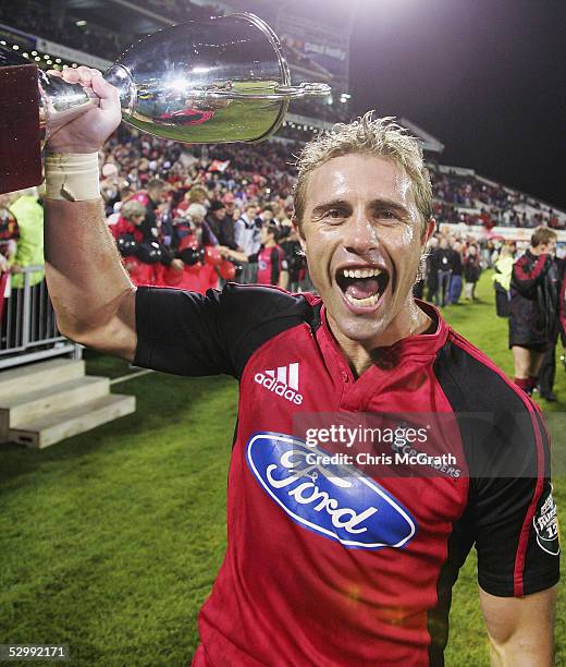 Justin Marshall of the Crusaders celebrates with the Super 12 trophy after defeating the Waratahs during the Super 12 Final between the Crusaders and...