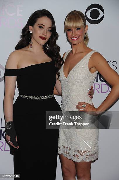 Hosts Kat Dennings and Beth Behrs pose in the press room at The 40th Annual People's Choice Awards at Nokia Theatre L.A. Live.