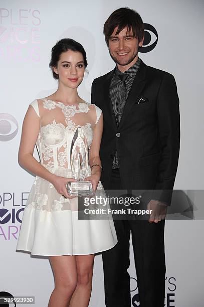 Actors Adelaide Kane and Torrance Coombs, winners of the Favorite New TV Drama award for "Reign", pose in the press room at The 40th Annual People's...