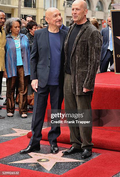 British actor Ben Kingsley posing with actor Bruce Willis after being honored with a Star on the Hollywood Walk of Fame.