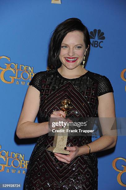 Actress Elisabeth Moss, winner of Best Performance in a Miniseries or Television Film for "Top of the Lake", posing at the 71st Annual Golden Globe...